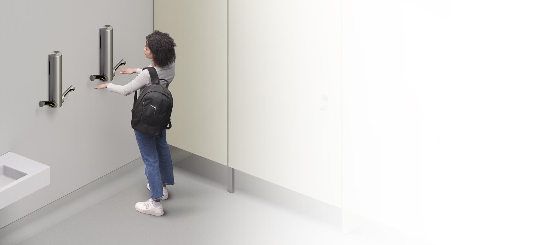 Woman drying hands with Dyson Airblade 9kJ