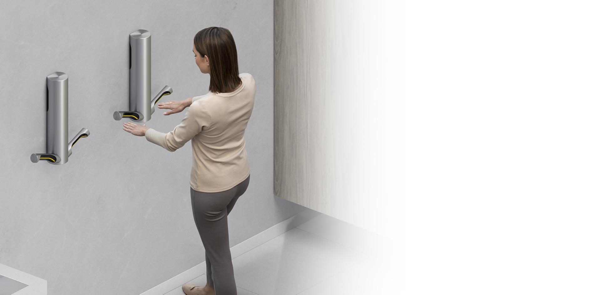 Woman drying hands with Dyson Airblade 9kJ