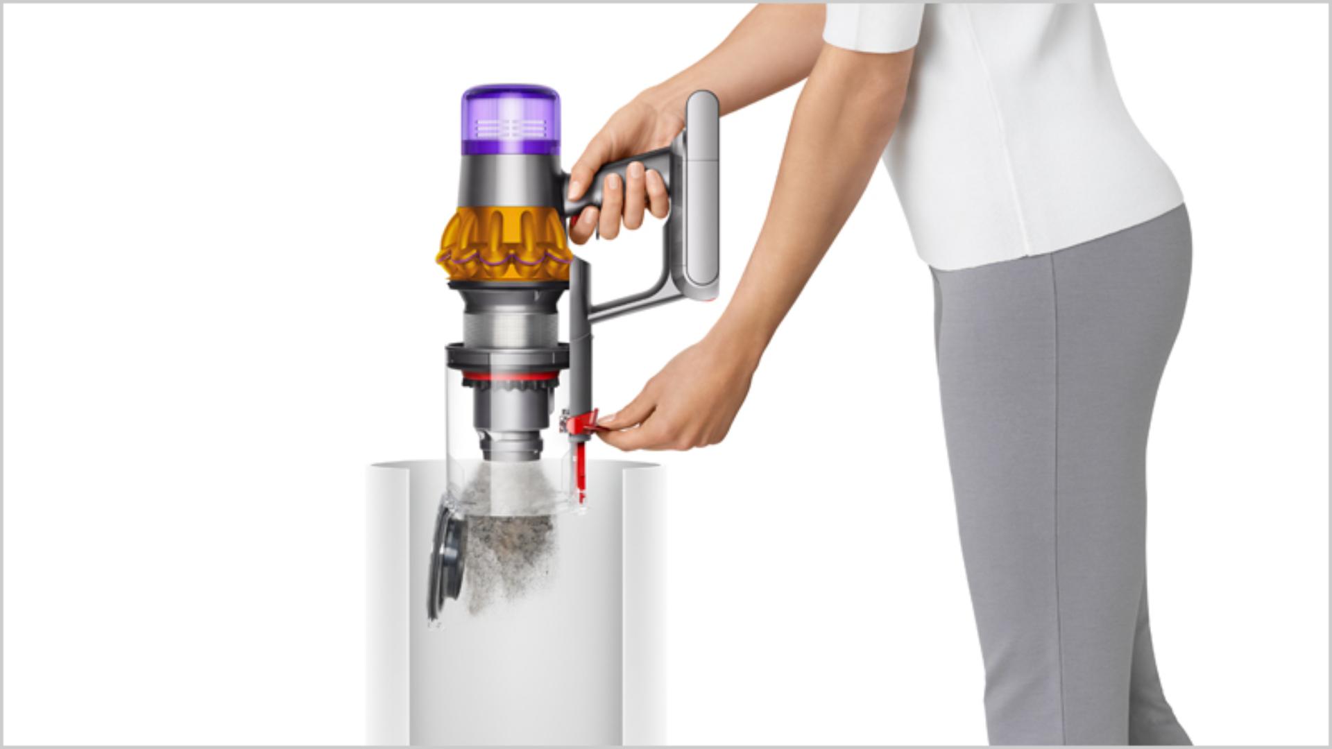 Woman emptying Dyson vacuum into the bin