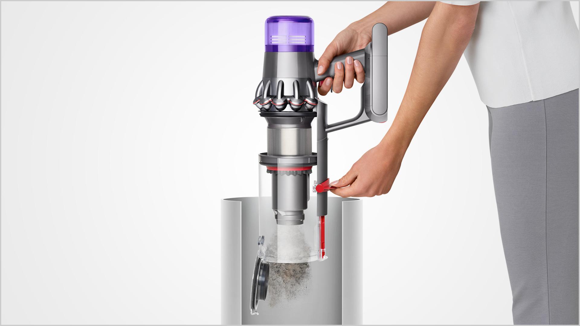 Woman emptying Dyson V11™ vacuum into bin