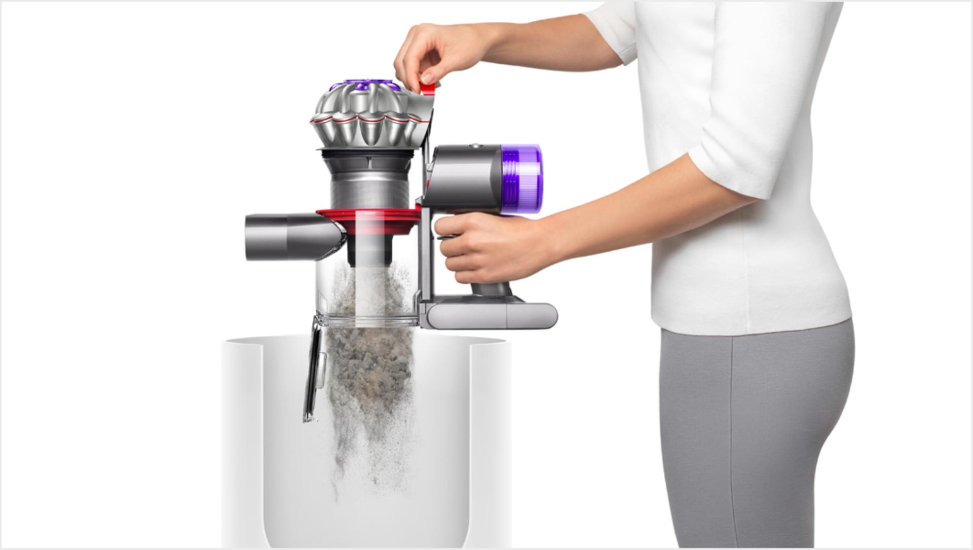 Woman emptying a Dyson V8 vacuum