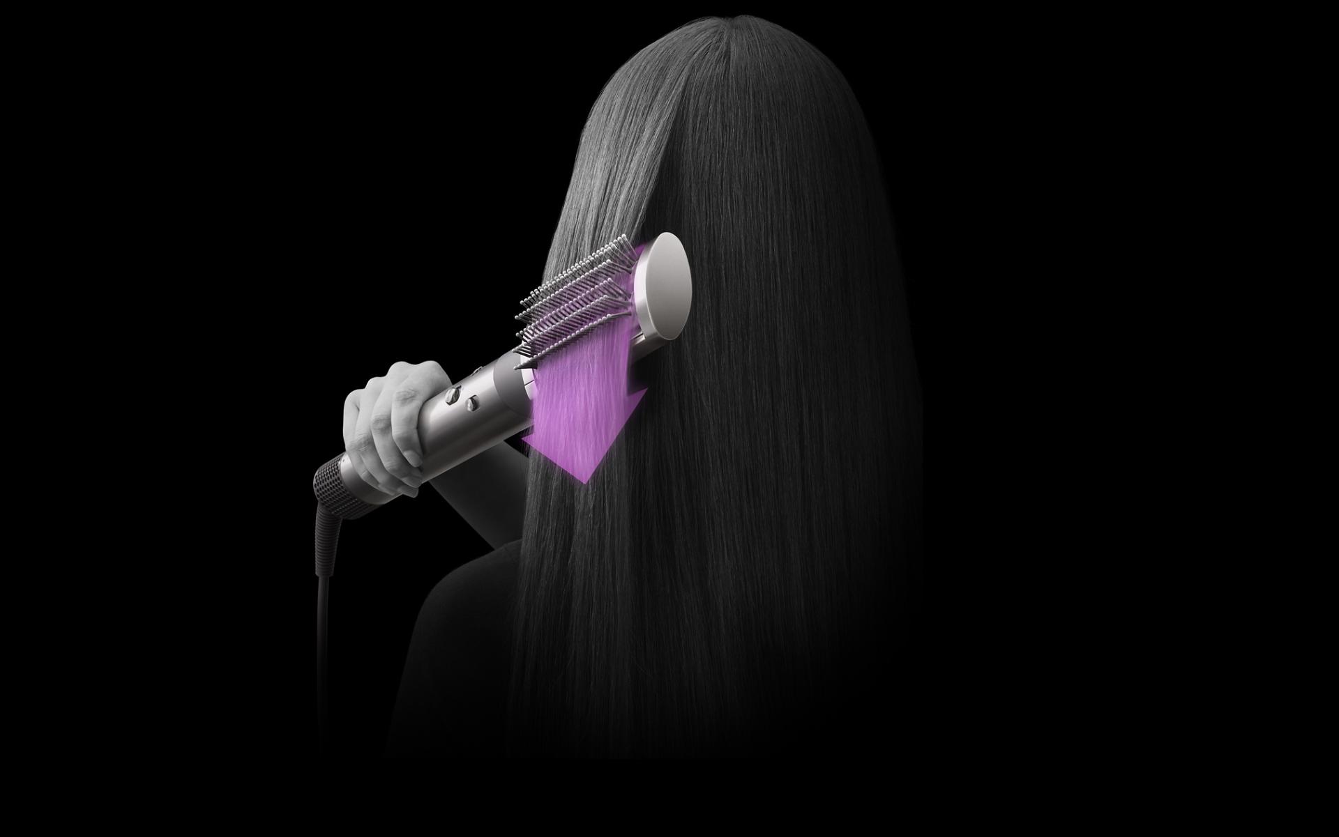 Dyson Airwrap styling hair with brush attachment