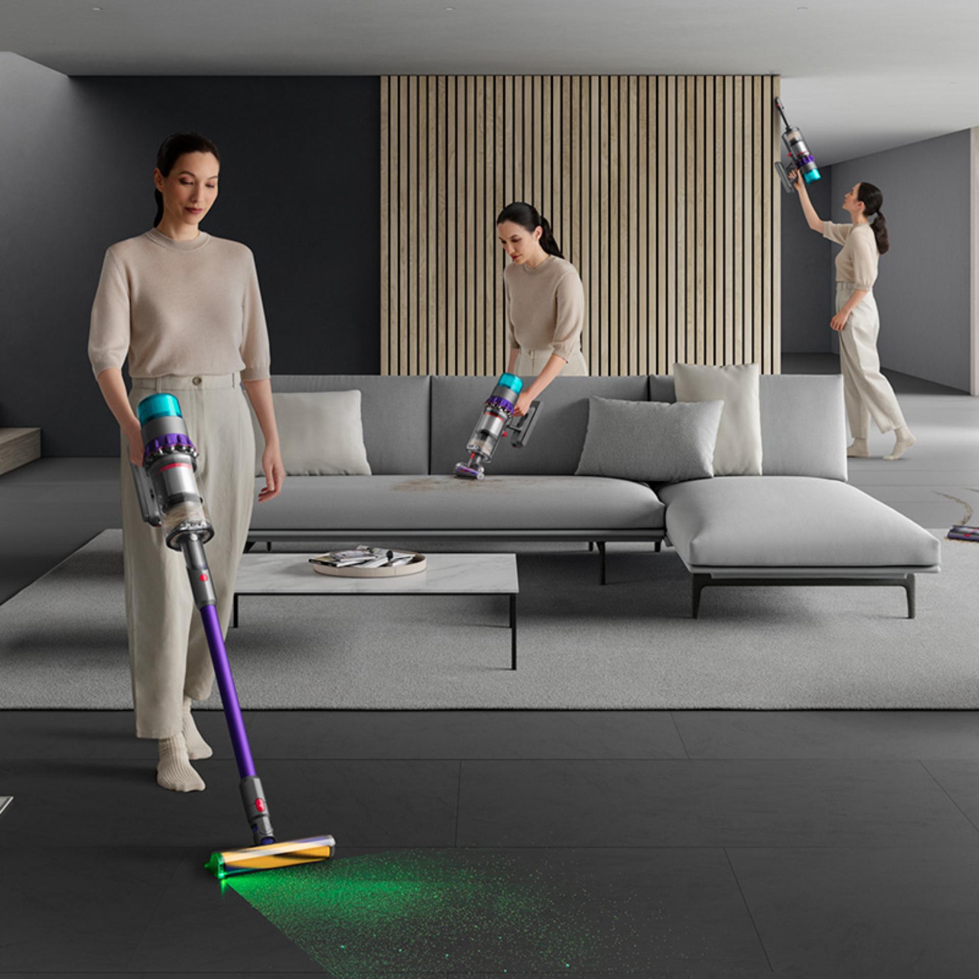 Woman shown using the Dyson Gen5detect as a stick and handheld vacuum around the home.