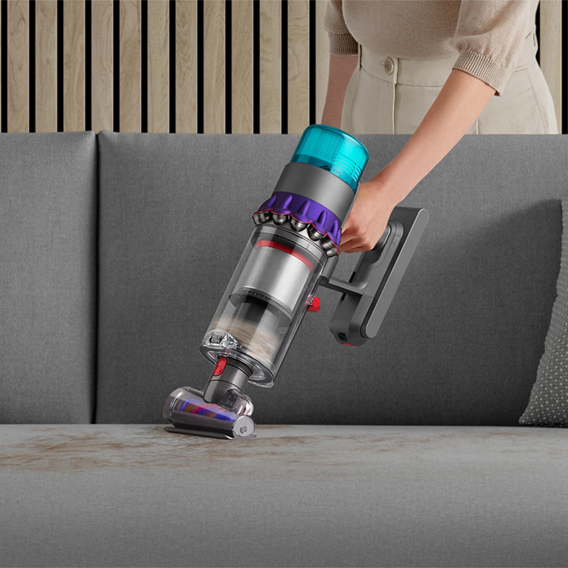 De-tangling Hair screw tool vacuuming a sofa.