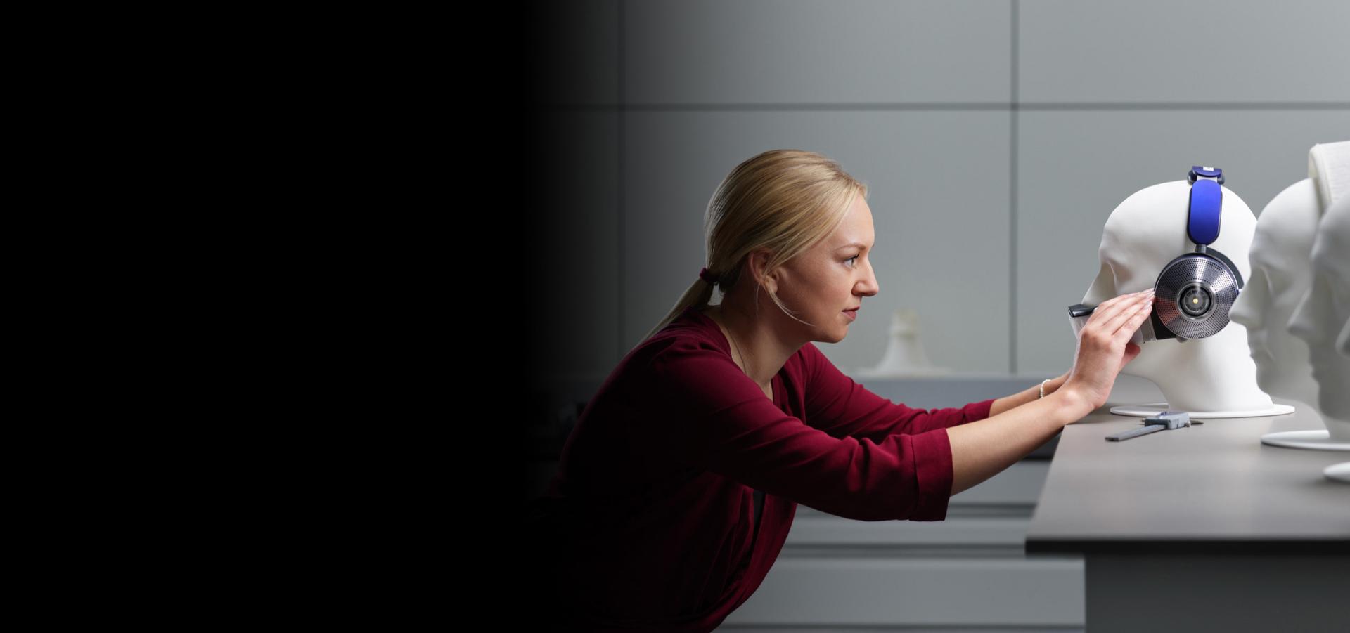 Engineer placing Dyson Zone headphones on a manikin.