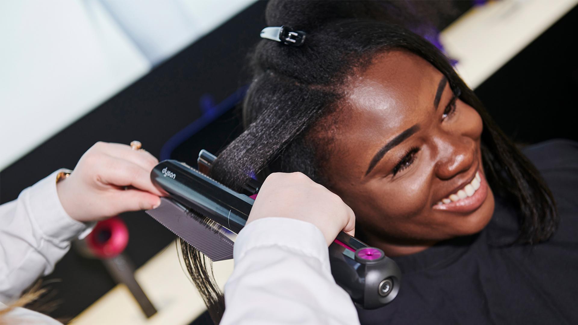 Dyson stylist helping someone with a demo