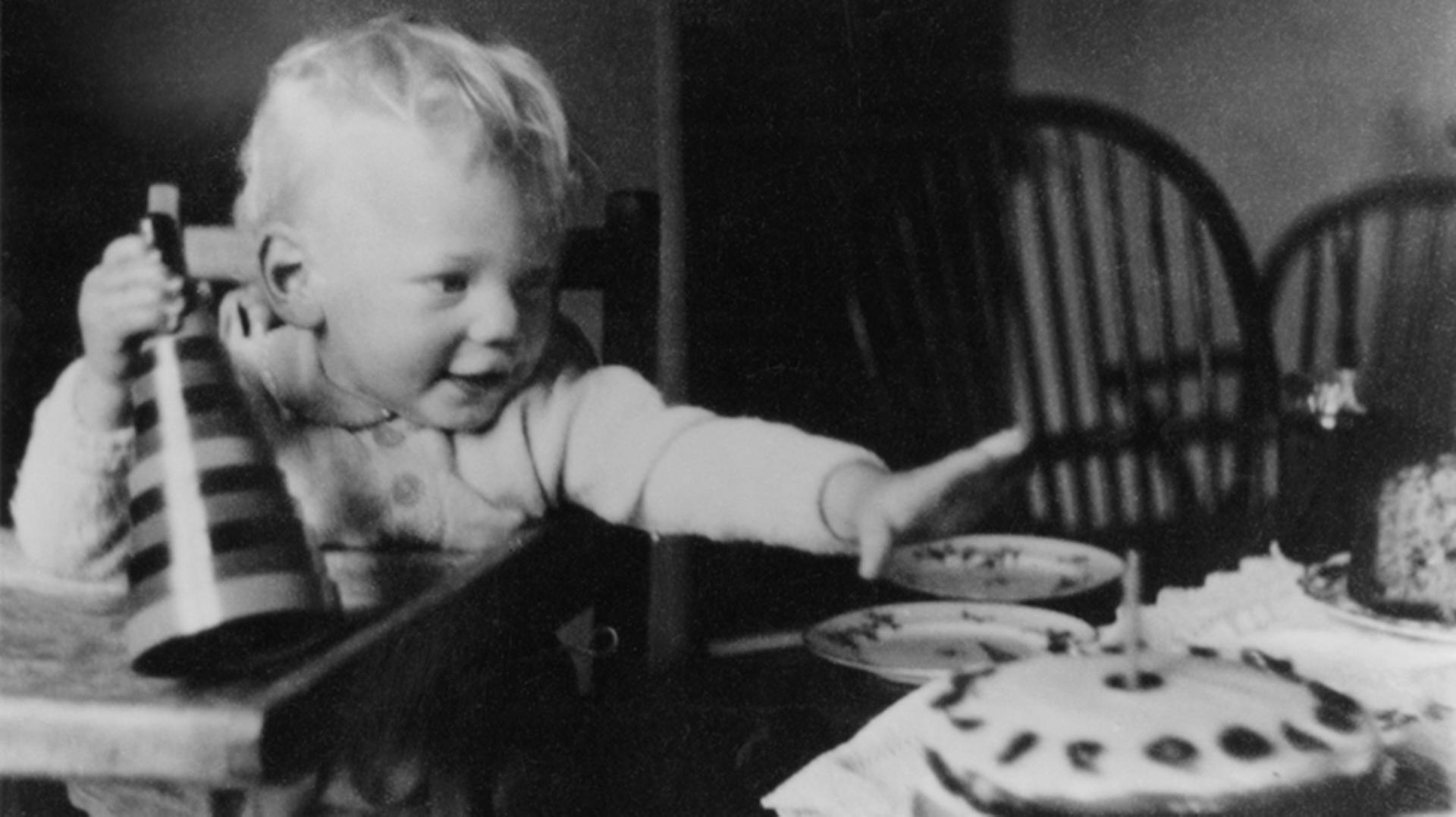 James Dyson on his first birthday reaching for his birthday cake