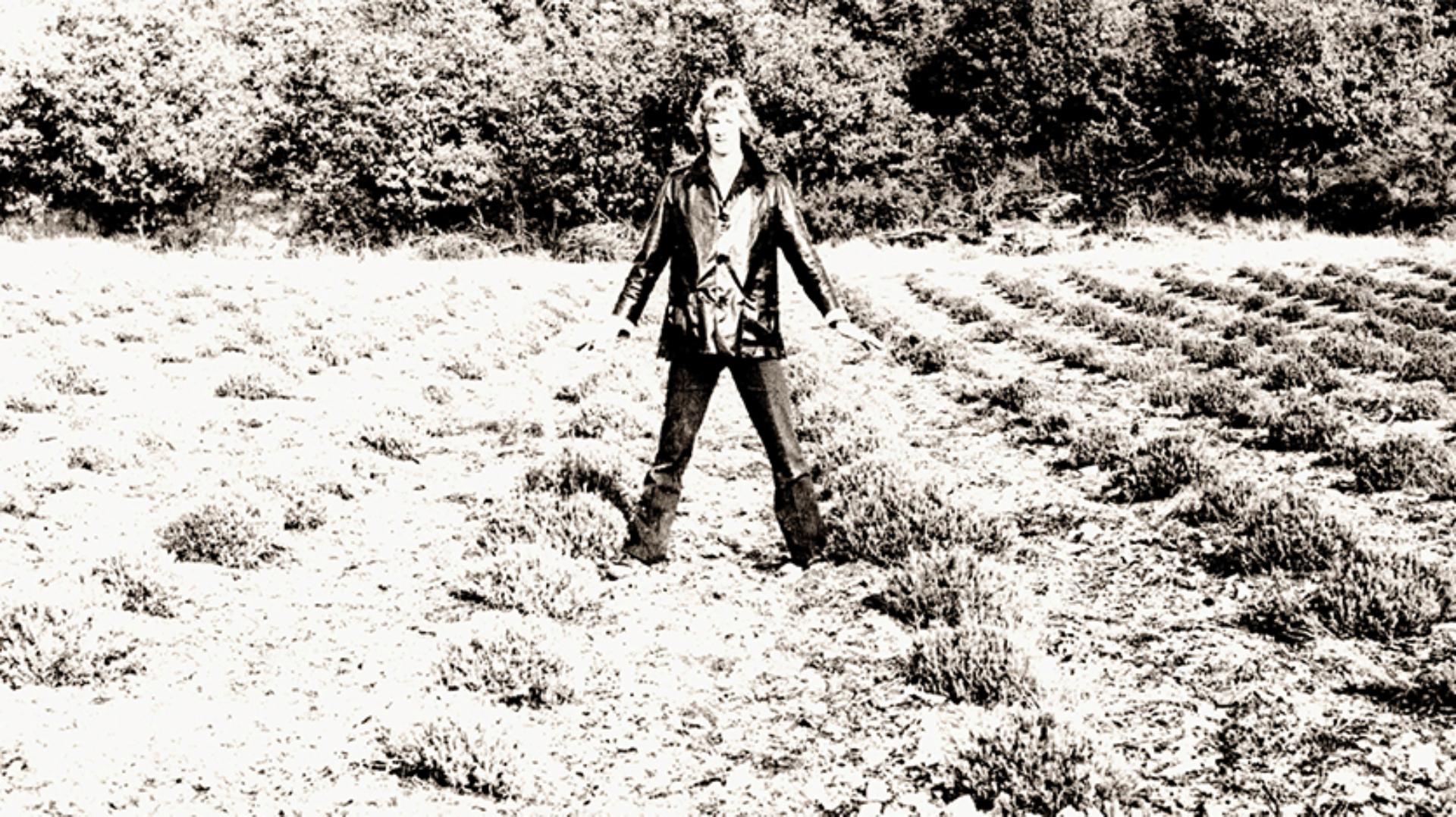 James Dyson standing astride cut lavender bushes