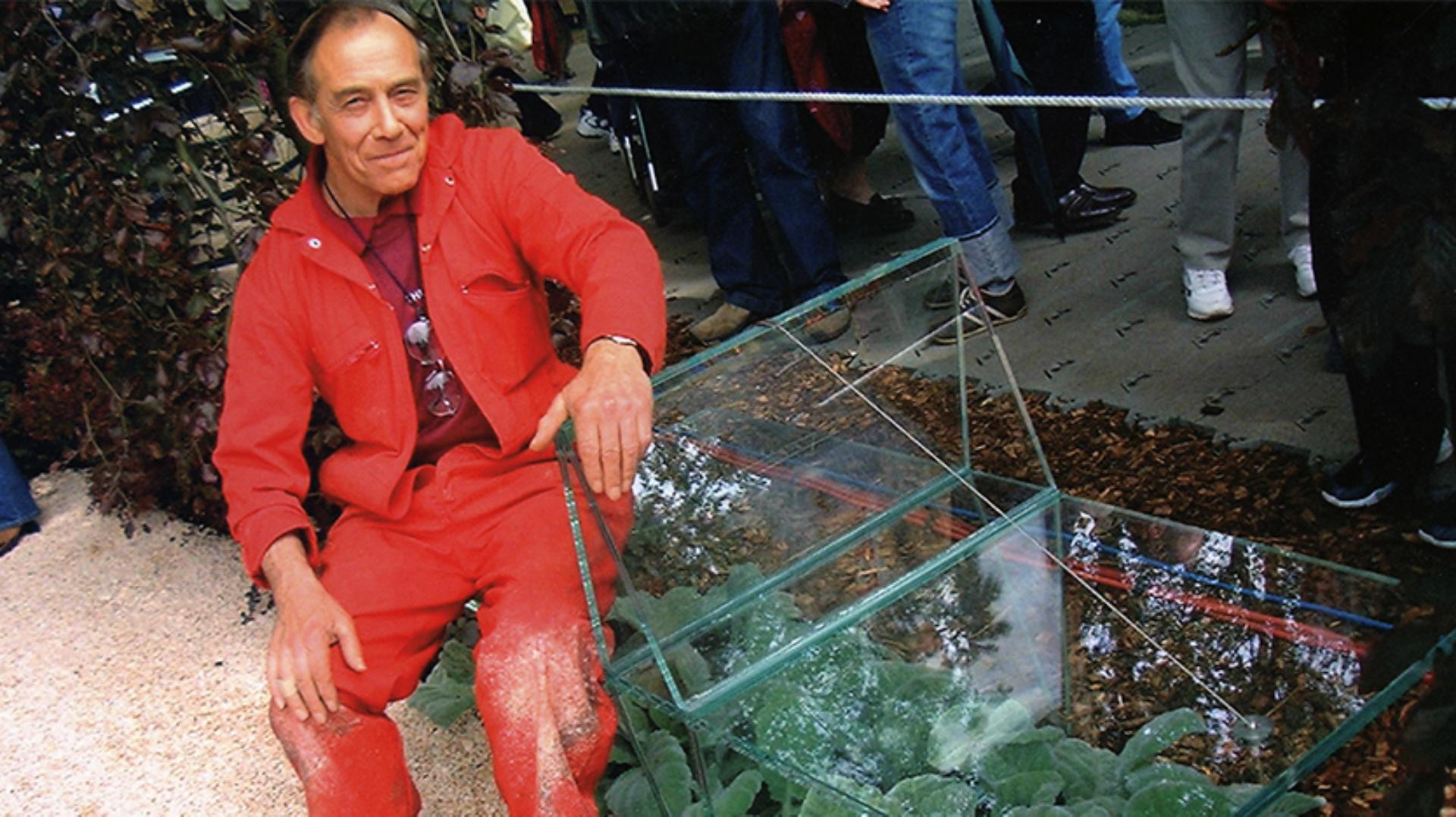 Derek Phillips sitting on an 'impossible' glass bench