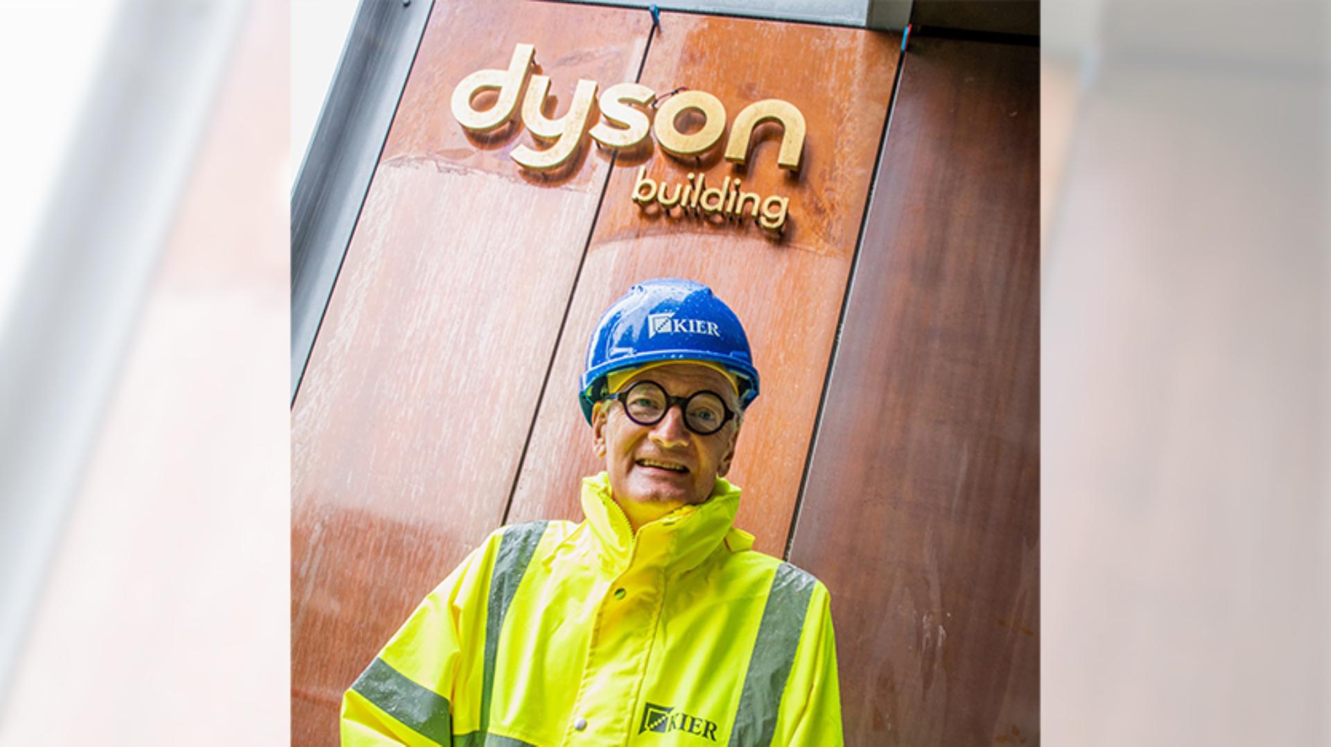 James Dyson standing in front of the Dyson building at Gresham school