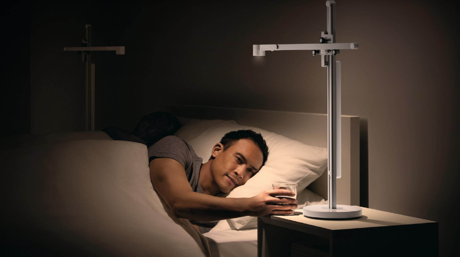 Man in bed beside the Lightcycle™ task light