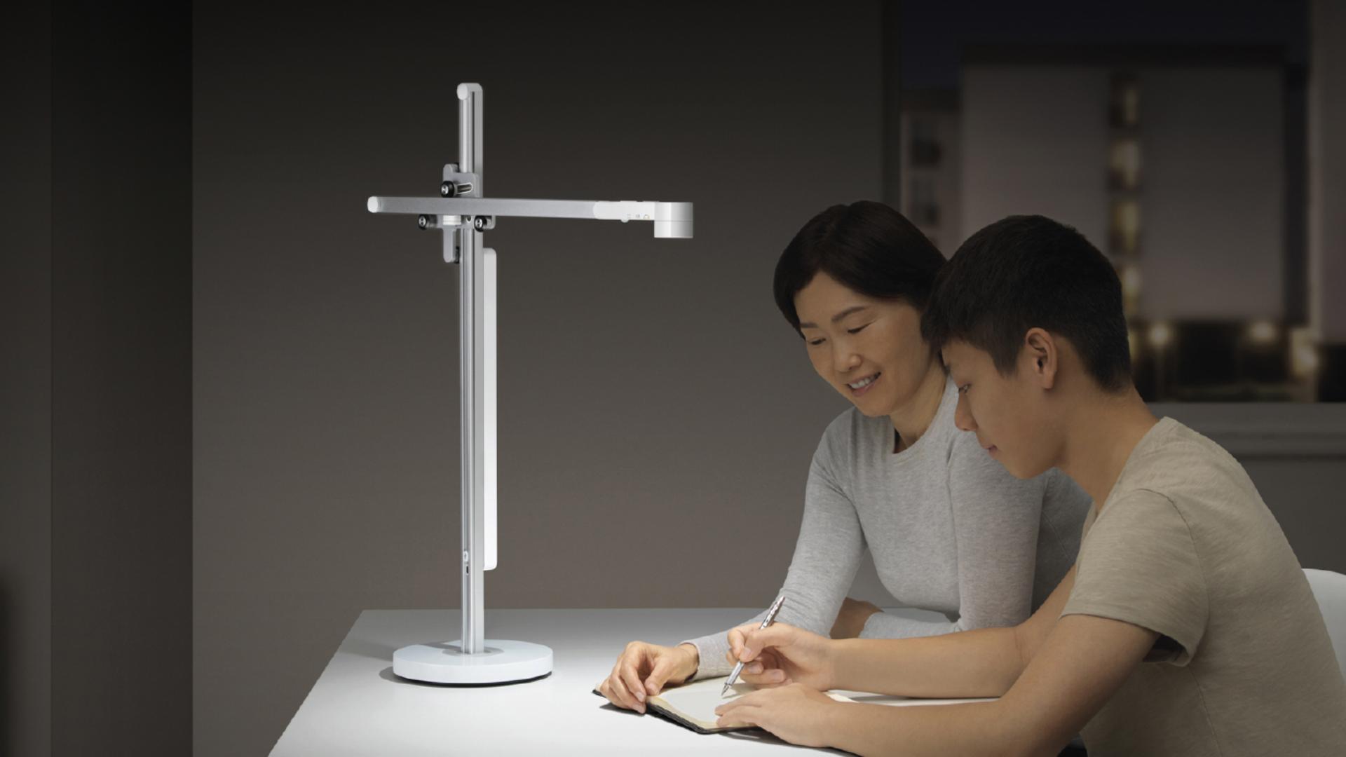 Two people studying alongside the Lightcycle™ task light