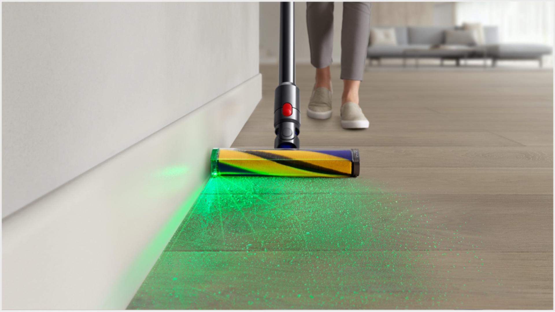 Dyson vacuum with Illuminated cleaner head being used to clean a hard floor.