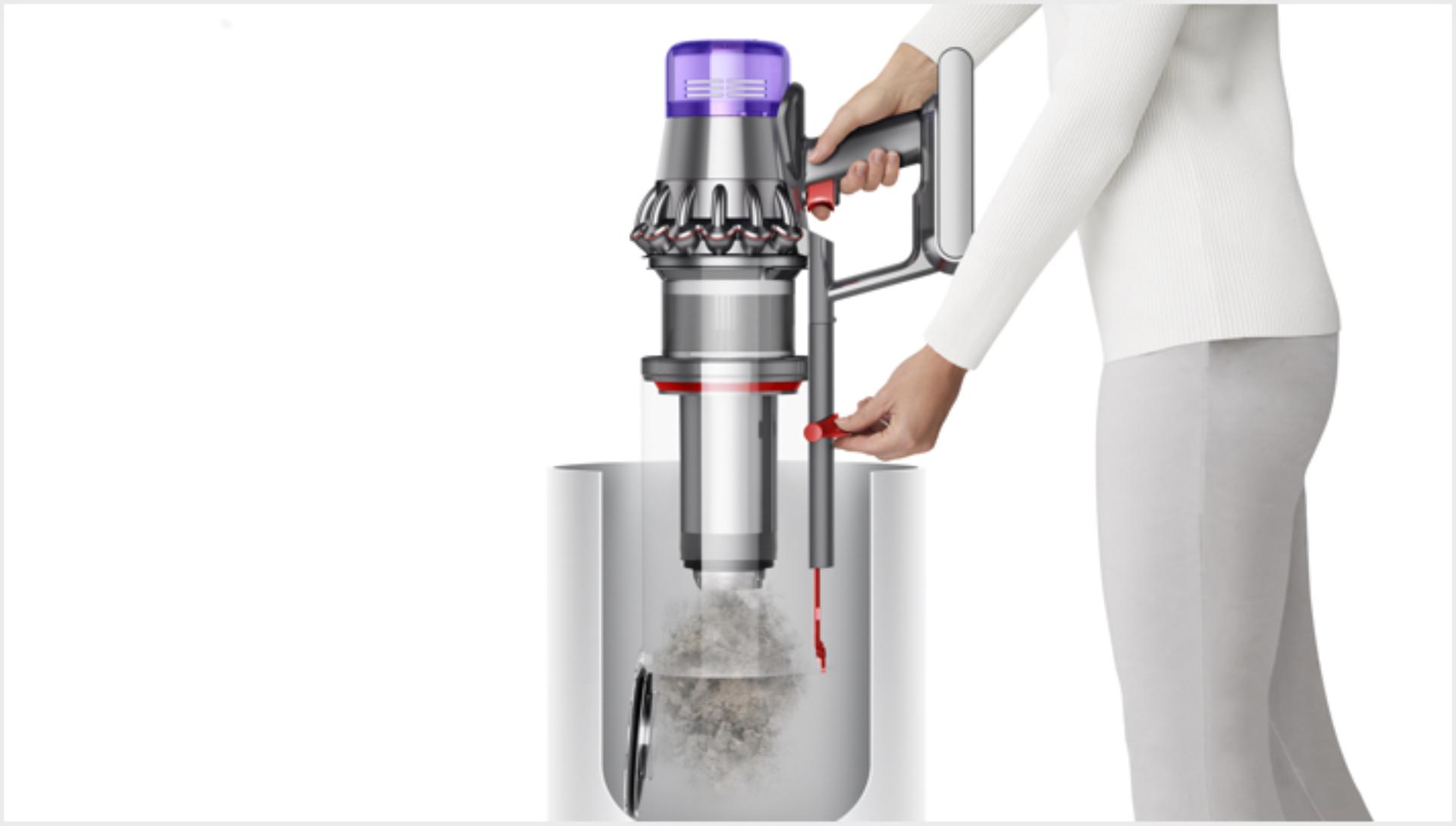 Woman emptying Dyson V11 Outsize vacuum into bin