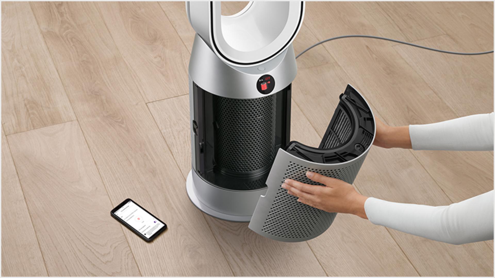 Someone changing a Dyson purifier's filter