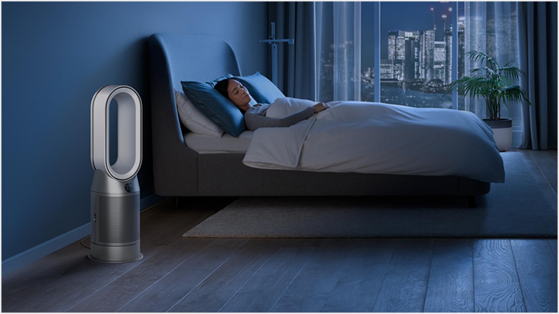 Someone sleeping peacefully in a hotel room purified by a Dyson purifier