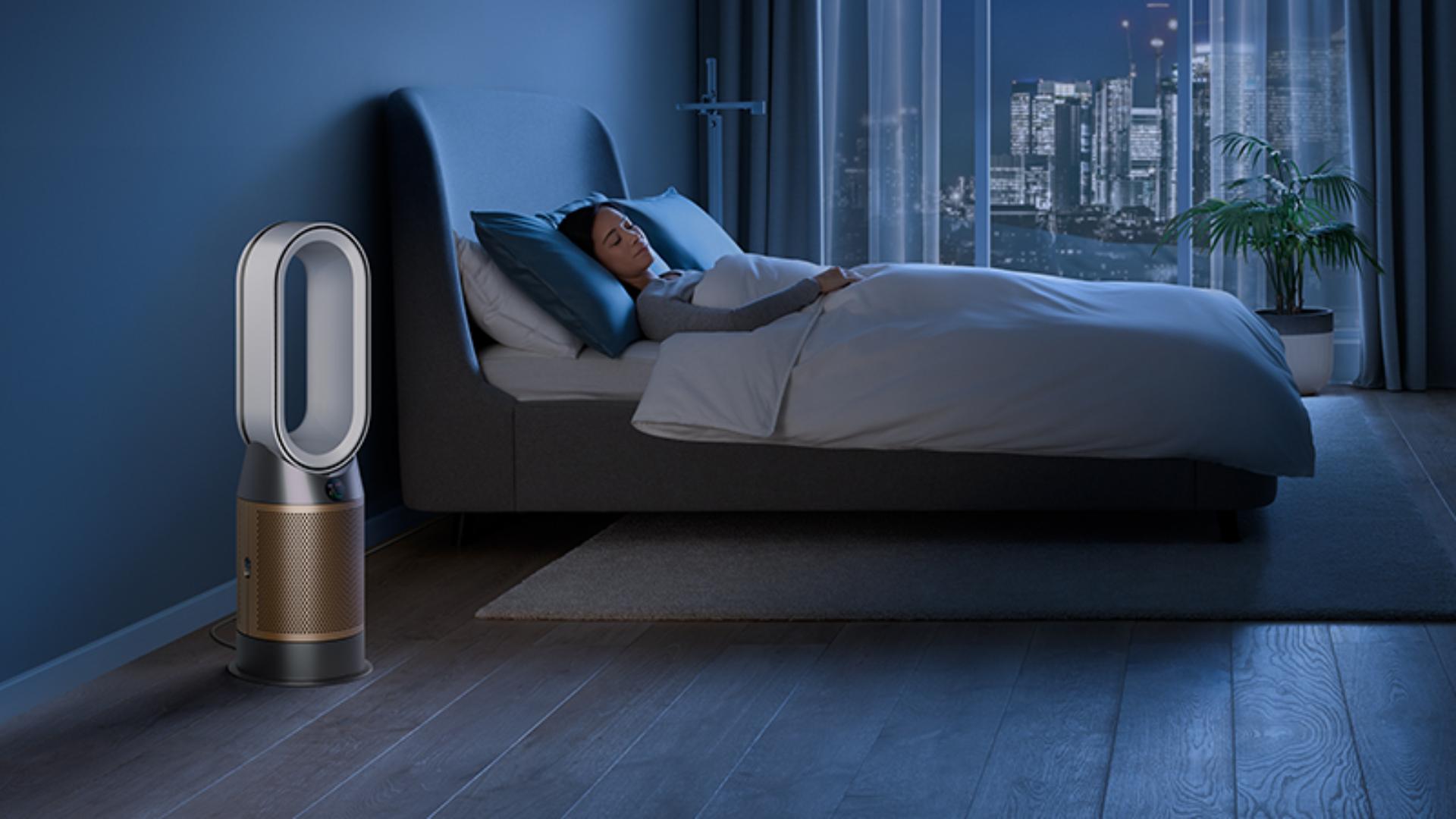 Dyson purifier in a dark bedroom with someone sleeping peacefully 