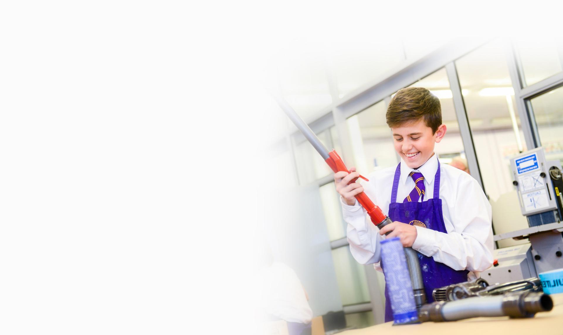 Schoolboy with vacuum cleaner	