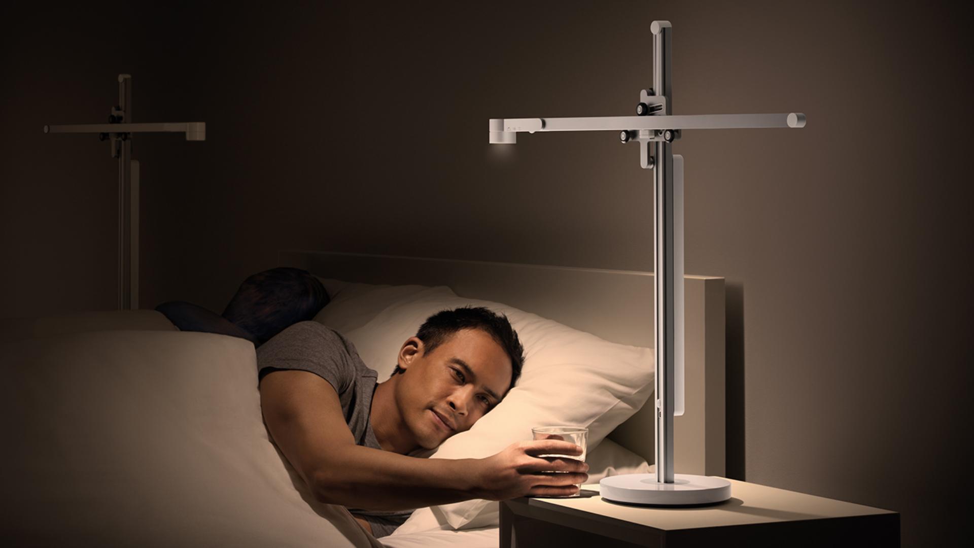 Man waking up under the Dyson Lightcycle task light