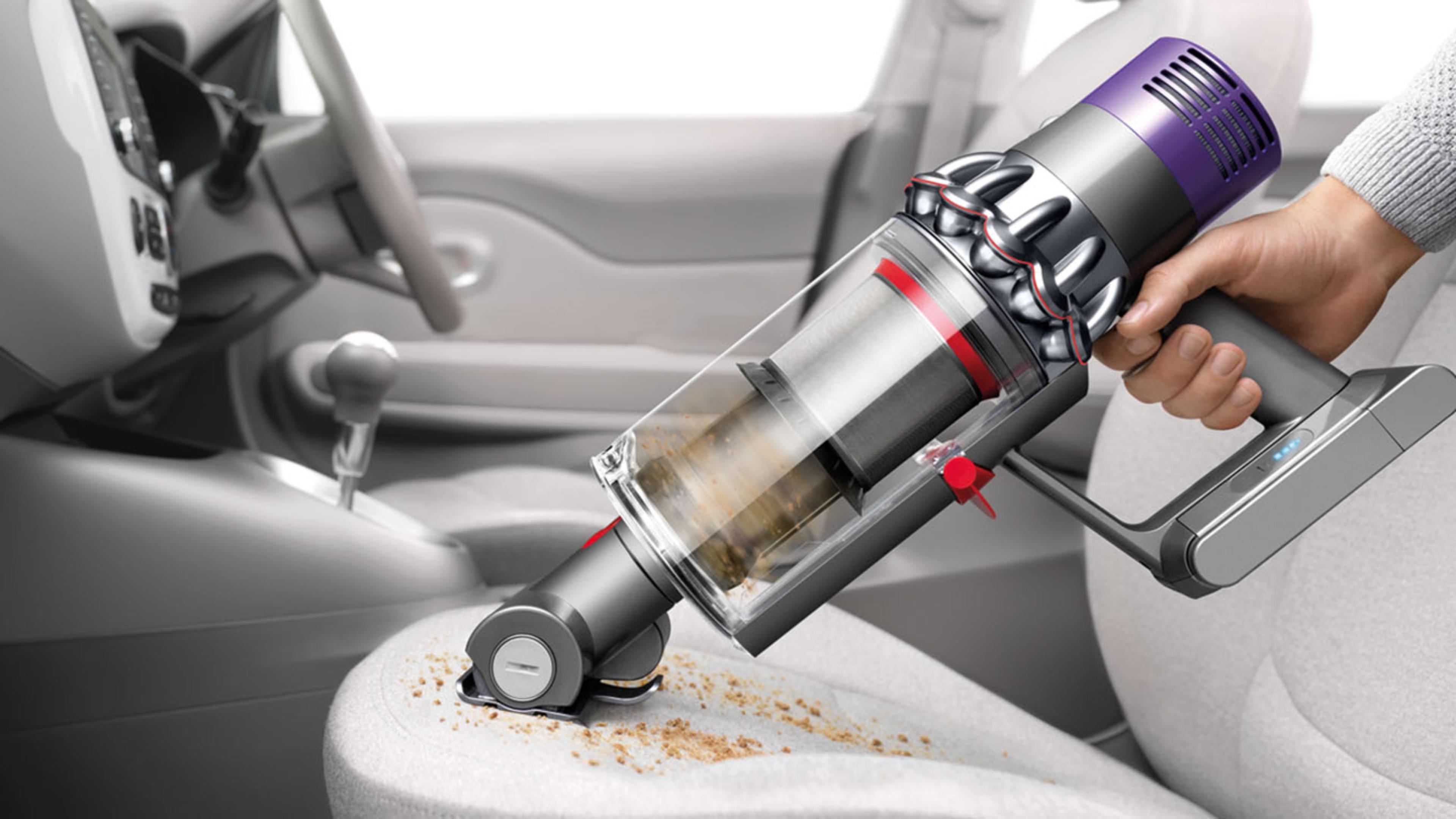 Dyson Cyclone V10™ vacuum in handheld mode cleaning car seat