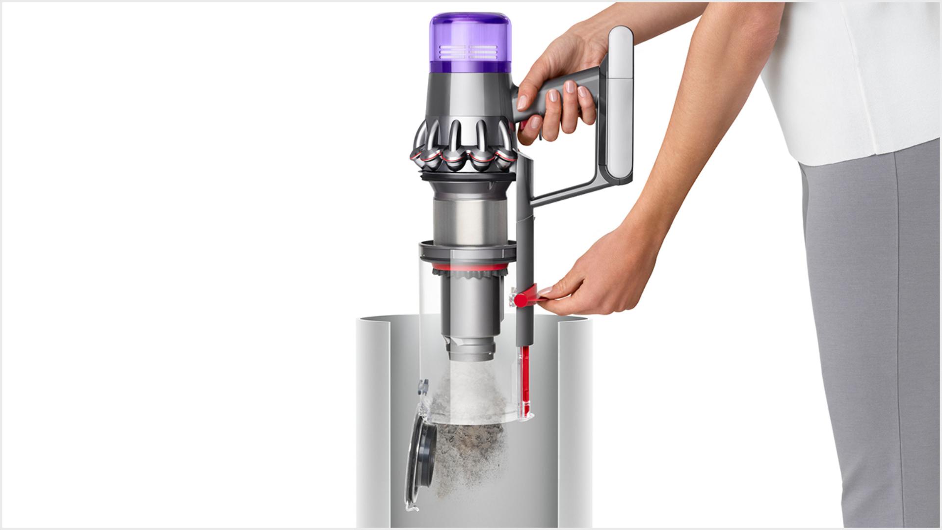 Woman emptying Dyson V11 vacuum into bin