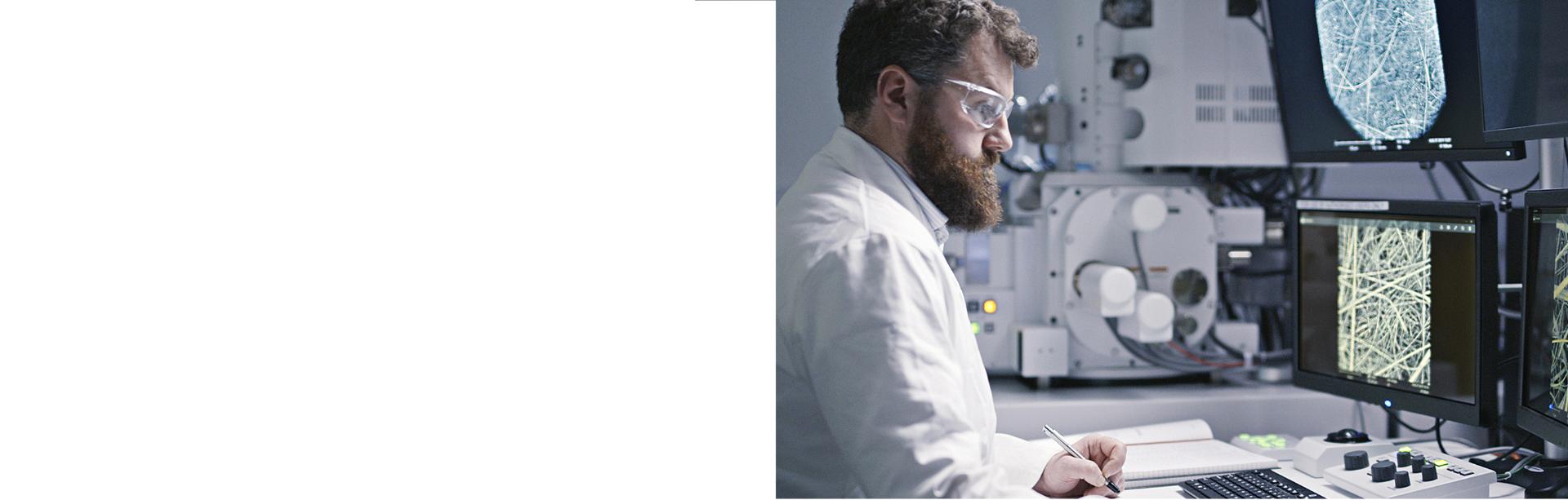 A scientist studying fibres on computer screens