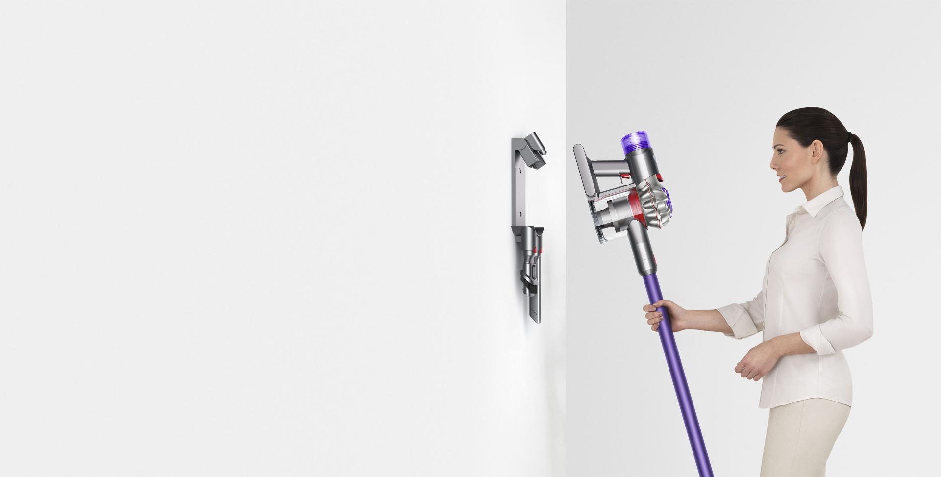 Woman storing Dyson V8 vacuum in Wall Dok