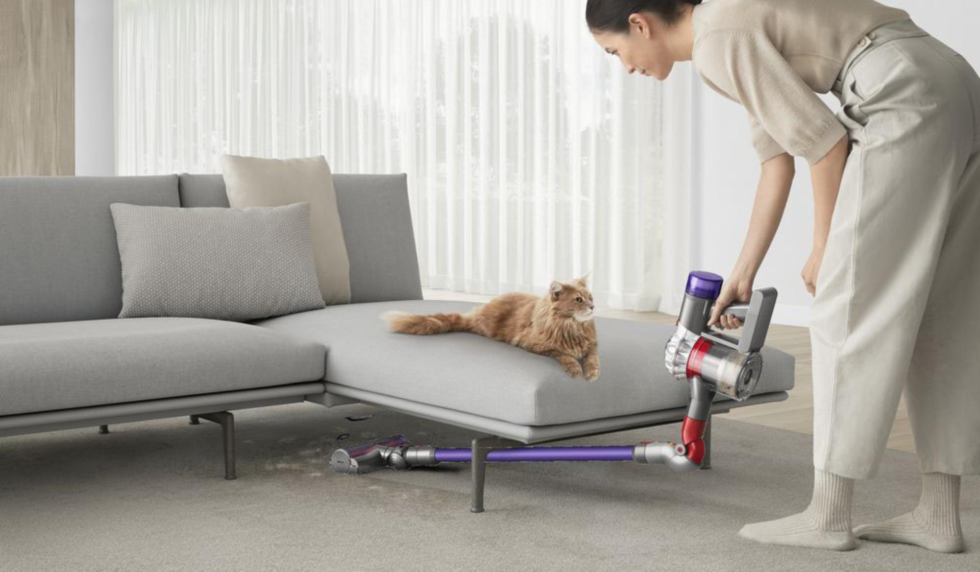 Woman using the up top adaptor under the sofa